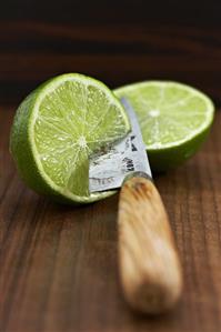 Two lime halves with knife