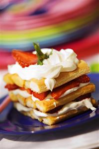 Layered dessert of strawberries, cream and sponge