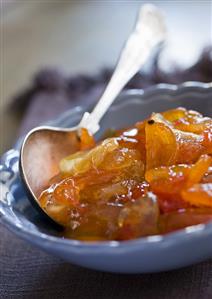 Kumquat marmalade in dish with spoon