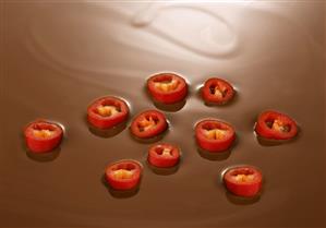 Chilli slices floating on chocolate fondue