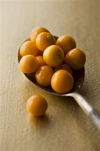 Several Cape gooseberries on spoon