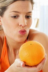 Woman holding an orange