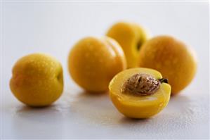 Whole apricots and one half of an apricot