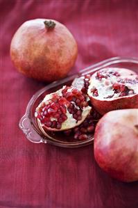 Pomegranates, whole and halved