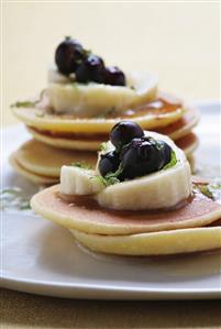 Small pancake towers with fruit and honey butter