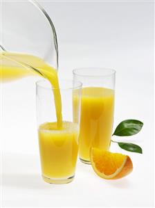 Pouring orange juice into glass