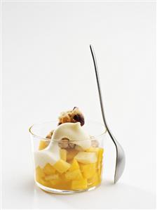 Pineapple compote with cream and nuts