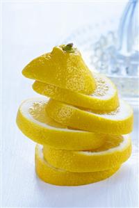 Stacked lemon slices, lemon squeezer in background