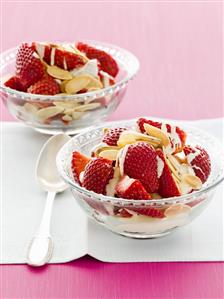 Strawberries with white chocolate sauce and flaked almonds