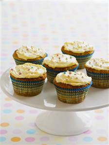 Several banana cupcakes on cake stand