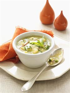 Vegetable soup (peas, courgettes, potatoes) with bacon