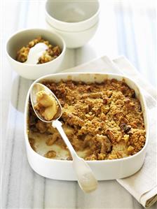 Apple and walnut crumble in a baking dish and small bowl