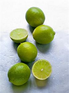 Several limes, whole and halved