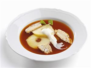 Warm rose hip soup with apple and whipped cream