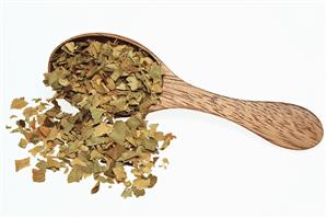 Dried bitter orange leaves on wooden spoon