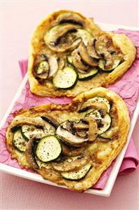 Heart-shaped courgette and mushroom puff pastry tarts