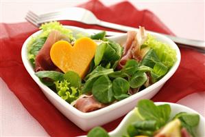 Salad leaves with ham and cheese heart