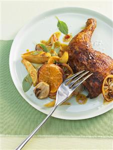 Marinated chicken legs with orange slices