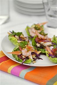 Papaya salad with prawns on lettuce leaves