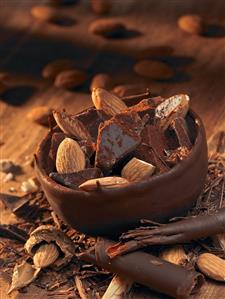 Chocolate bowl with pieces of chocolate and almonds