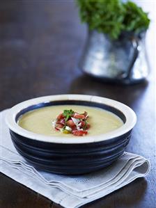 Mushroom soup garnished with onions and tomatoes