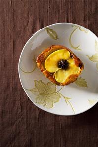 Apple in batter with star anise (overhead view)