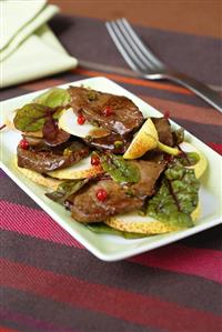 Slices of beef fillet on pear and sorrel