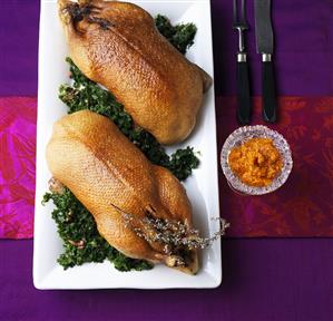 Two ducks on kale with persimmon chutney