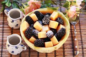 Melon and blackberry salad with icing sugar