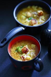 Lentil and potato stew in a pan and a cup