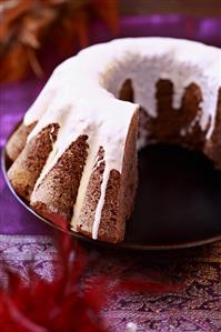 Ring cake with white chocolate icing, a piece removed