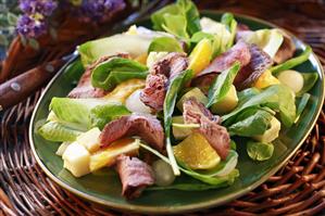 Salad leaves with beef, avocado, oranges and basil