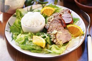 Pork fillet with orange slices and rice