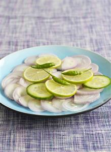 Onion salad with cucumber and lime slices and chillies