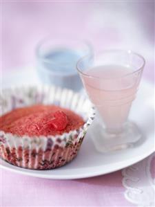 Red cupcake with blue chocolate sauce and liqueur