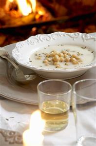 Chick-pea soup on table in front of open fire