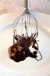 Melted chocolate on plate with whisk