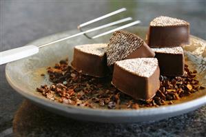 Chocolates and chocolate fork on plate