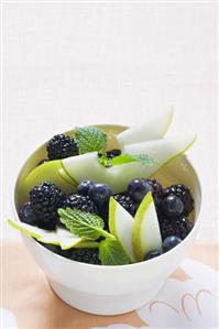 Bowl of autumn berries and pear slices