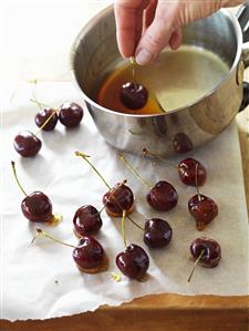 Dipping cherries in caramel