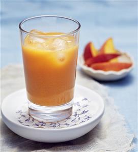 Peach and carrot juice with ice cubes