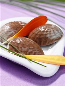 Chocolate shells with orange and cardamom filling