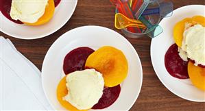 Poached peaches with raspberry puree and vanilla ice cream