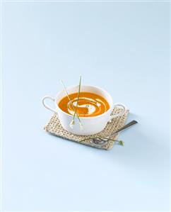 A cup of carrot and mango soup