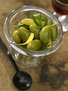 Jar of olives with rosemary and lemon