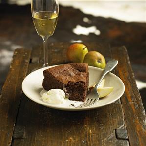 Piece of chocolate cake with vanilla ice cream and pears
