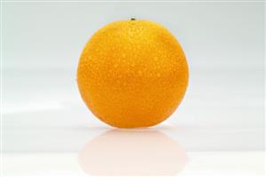 An orange with drops of water