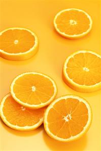 Several orange slices on orange background