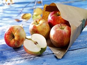 Fresh apples with paper bag