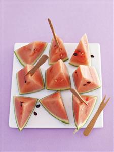 Pieces of watermelon with wooden forks